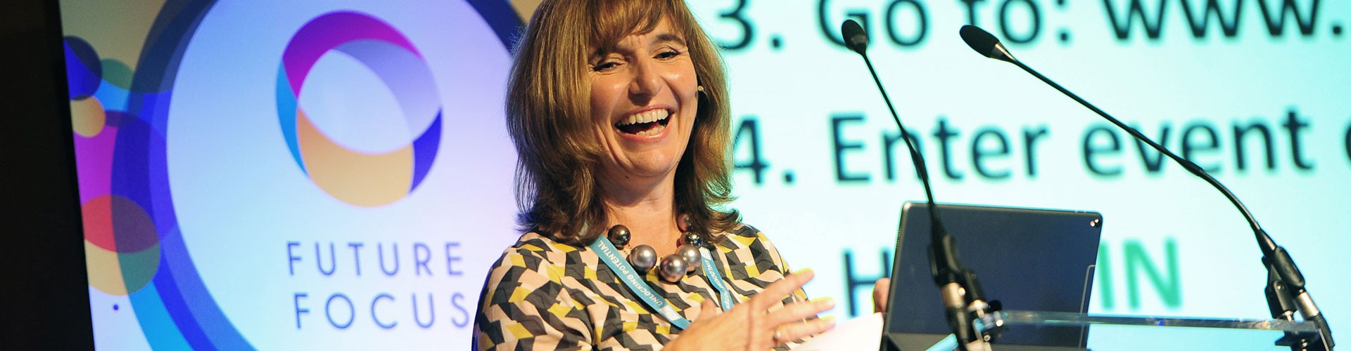 smiling woman giving a presentation at a future focus event